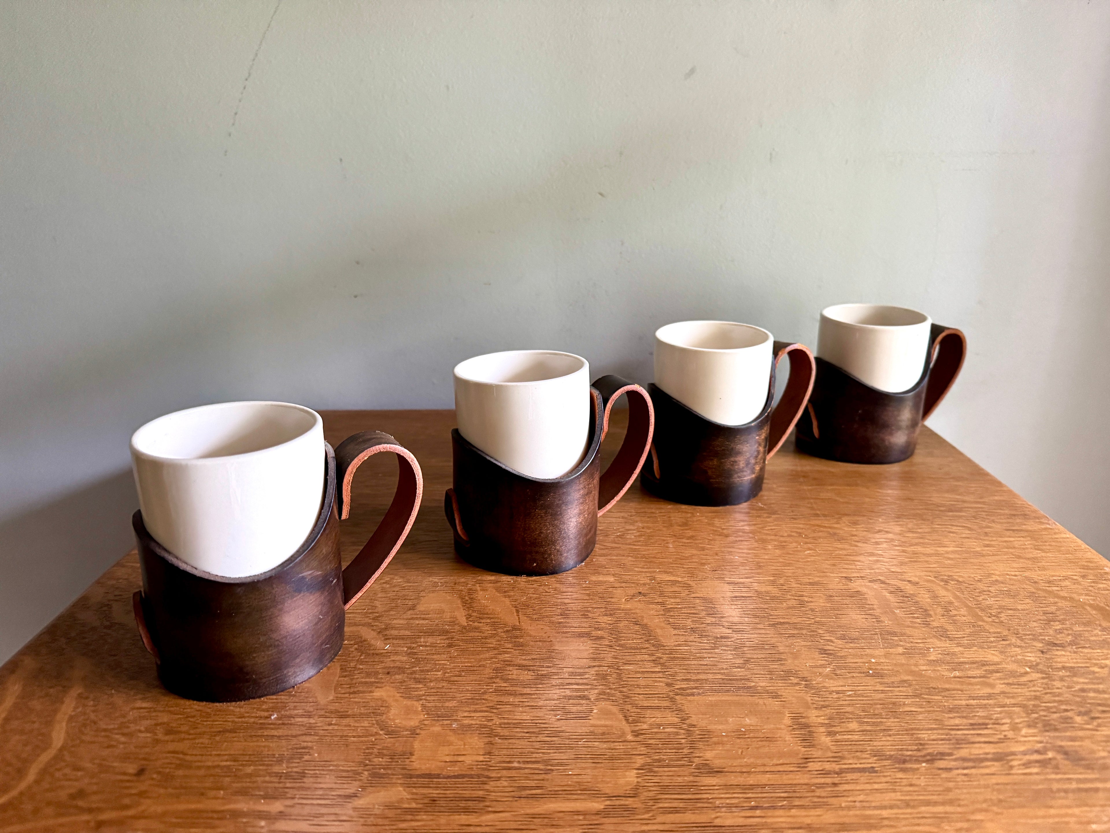 Set of 4 Tooled Leather Mug Holders with Handles and White Ceramic Cups