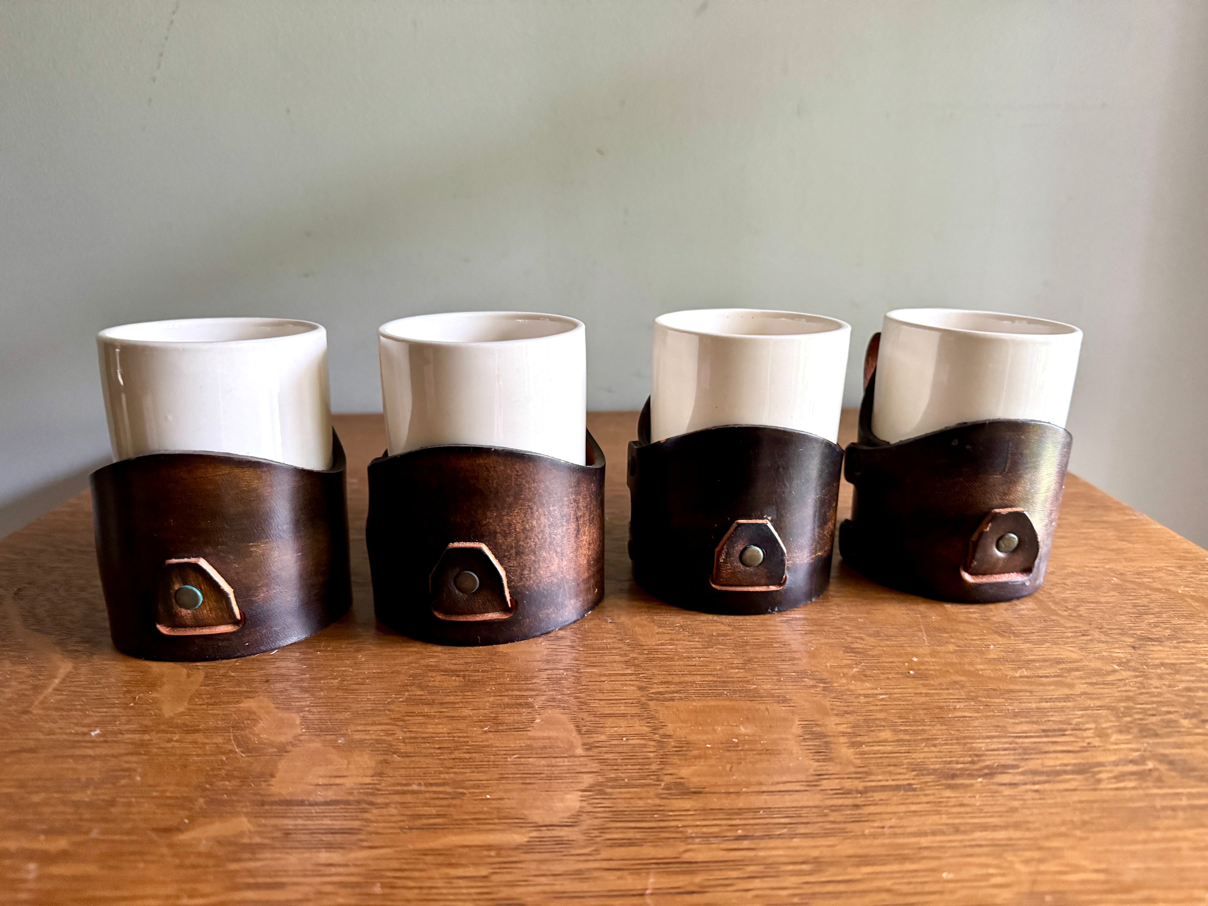 Set of 4 Tooled Leather Mug Holders with Handles and White Ceramic Cups