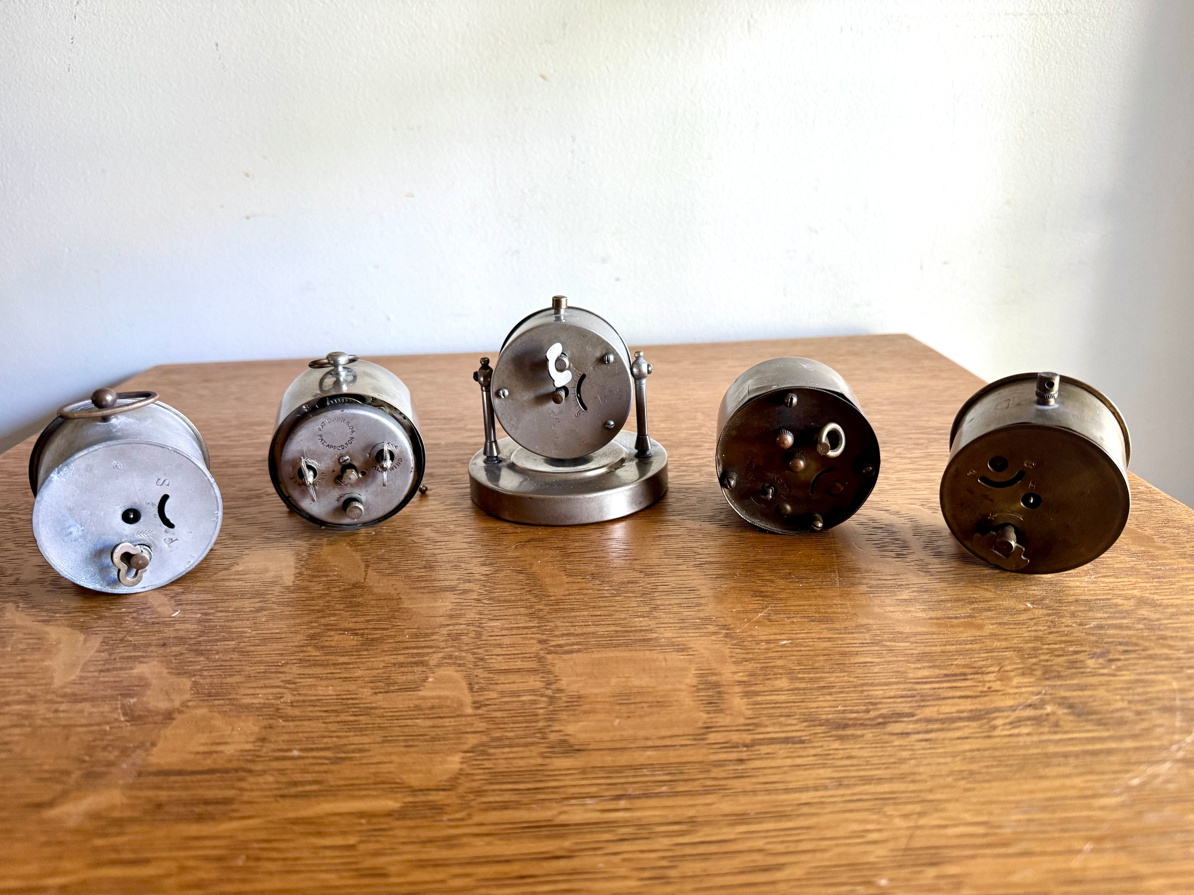 A Mixed Lot of 5 Small Traveling Alarm Clocks ~ New Haven ~ K.C. Co. ~ Howard Thermostat Co. (Parts)