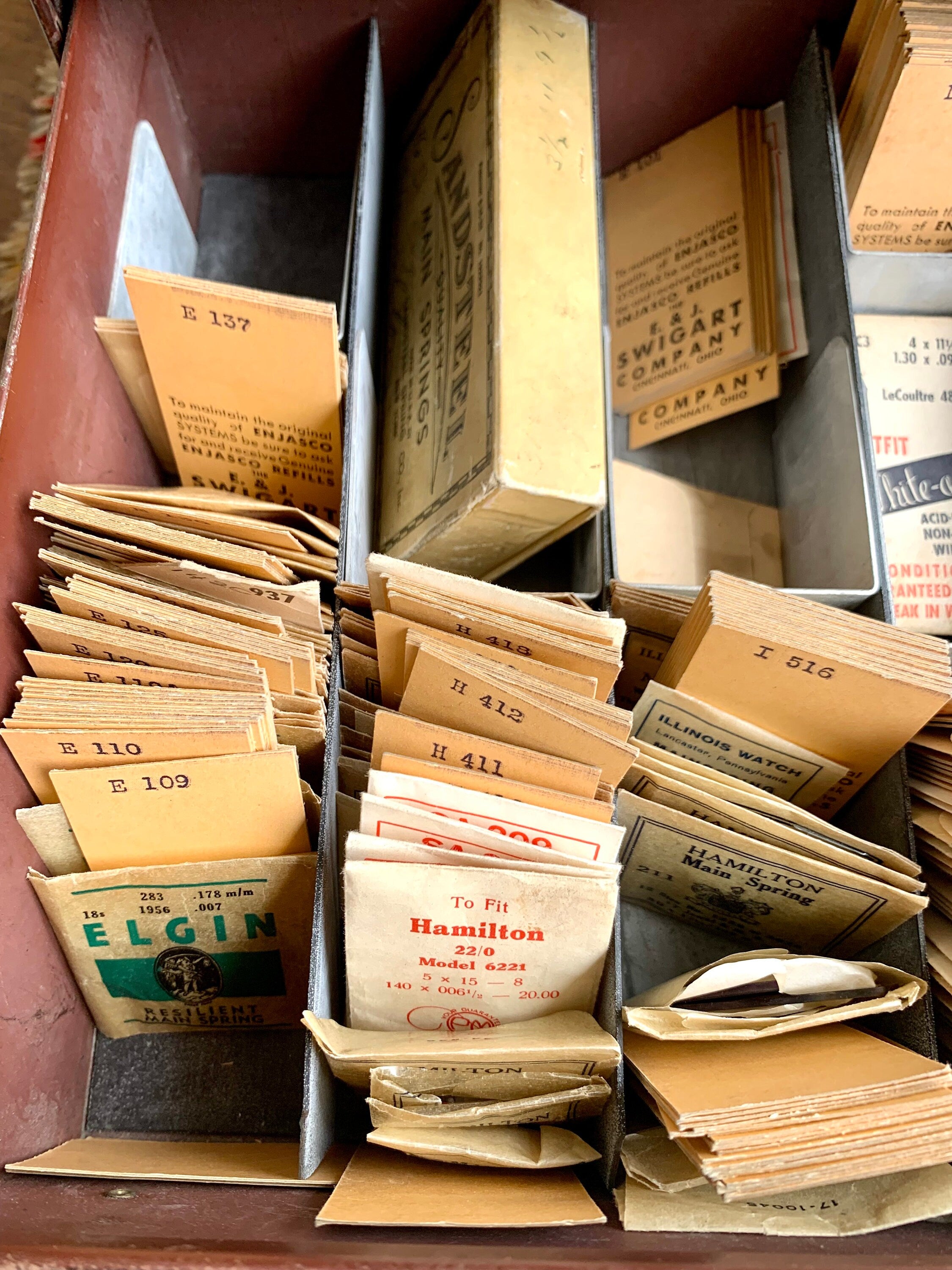 E&J Swigart Co. Cabinet With Contents | Vintage 2 Drawer Swigart Watch Repair Parts and Cabinet | Faux Woodgrain Parts Cabinet | Watch Springs